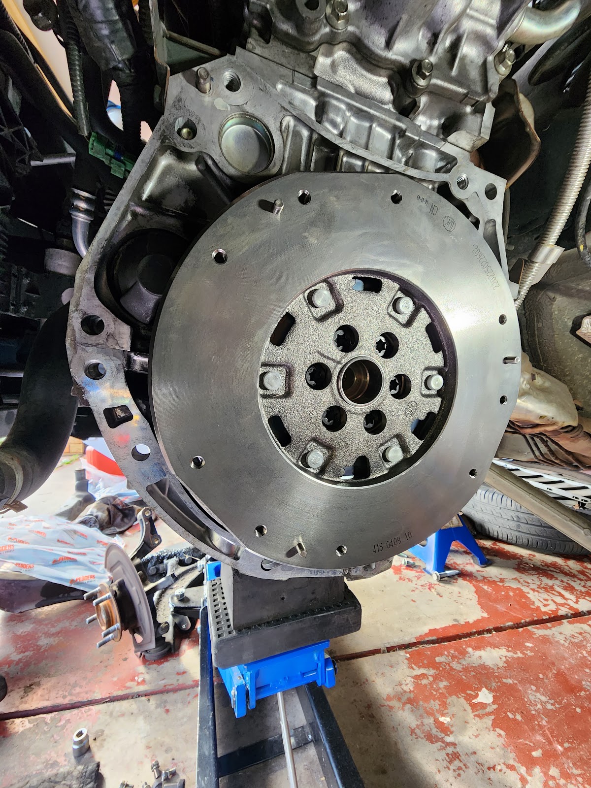A flywheel fitted to an engine on a stand